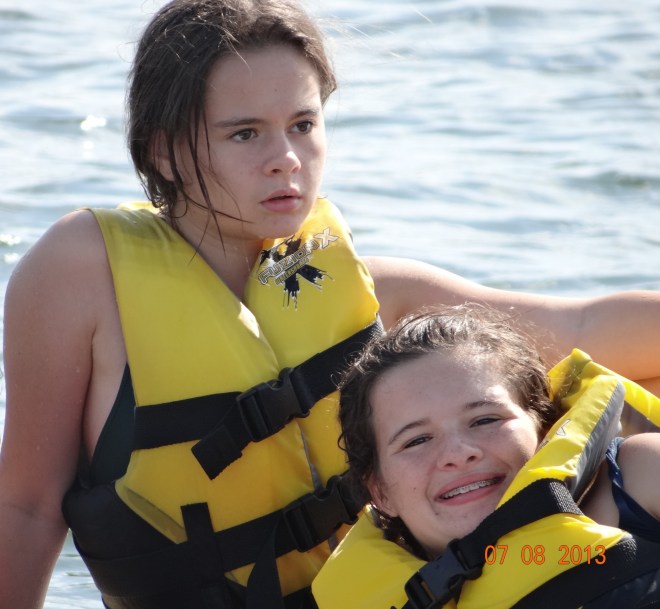 Emma playing the role of dramatic model and Liv smiling sweetly.